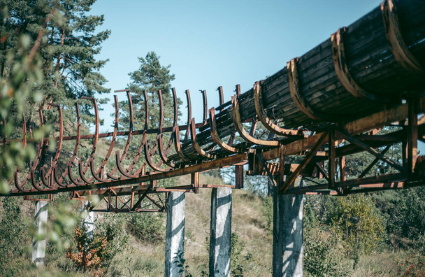 Old abandoned wooden bobsleigh track in summer by daylight - Photo, Image