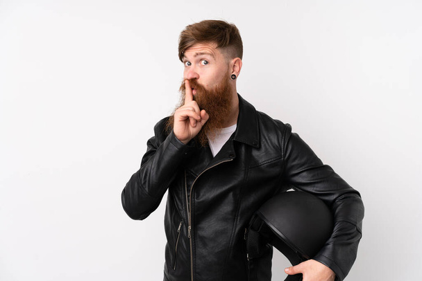 Redhead man with long beard holding a motorcycle helmet over isolated white background doing silence gesture - Photo, Image