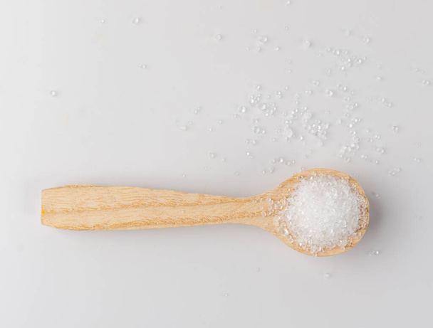 "Heap of White Powder of Lemon Acid, Clay or Bentonite in Wooden Spoon Black Background". Citrus Acid, Calcium, Gypsum or Plaster Top View - Фото, зображення
