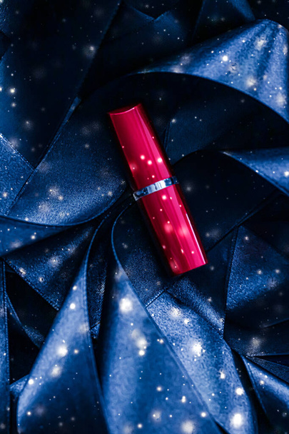 Red lipstick on blue silk and shiny glitter background, luxury make-up and beauty cosmetic - Foto, imagen