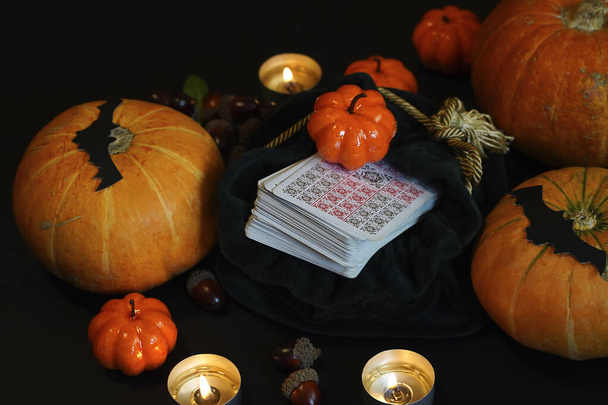 Defocused mystic ritual with tarot cards, and candles. Halloween concept, black magic or fortune telling rite with occult and esoteric symbols. . High quality photo - Photo, Image