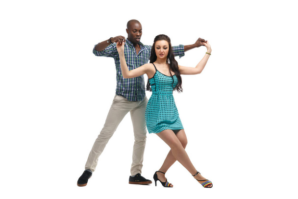 Caucasian girl and black man dancing samba isolated on white background. - 写真・画像