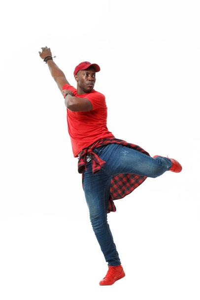 Young black stylish guy in red in a jump isolated on white background. - Фото, зображення