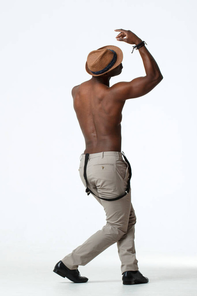 Athletic black man dancing view from the back, on a white background. - Fotoğraf, Görsel