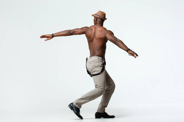Athletic black man dancing view from the back, on a white background. - Фото, изображение