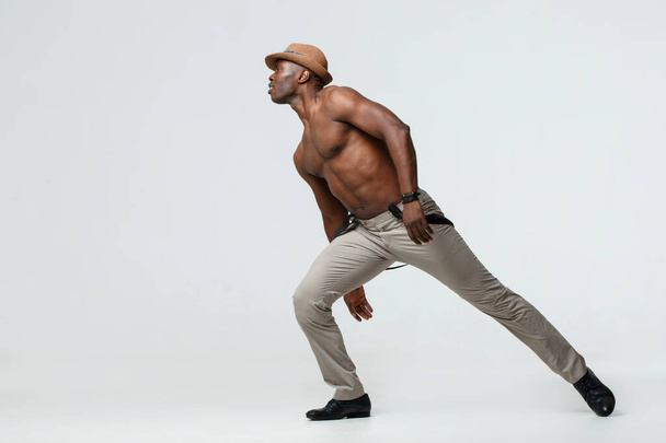 Athletic black man dancing, on a white background. - Foto, imagen