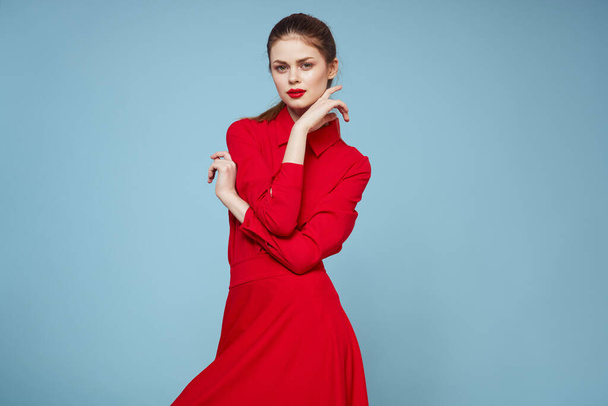 attractive woman in bright clothes on blue background gesturing with hands and red lips makeup cropped view emotions - Fotografie, Obrázek