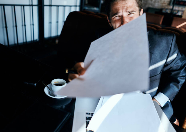 Liikemies kahvilassa puku edessä kannettavan tietokoneen tunteita viralliset asiakirjat tekniikka - Valokuva, kuva