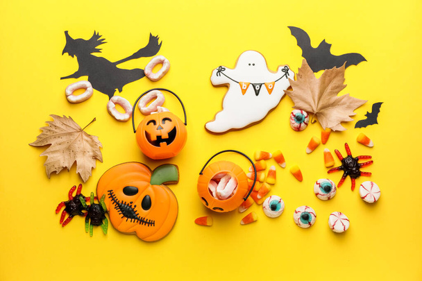 Halloween composition with tasty treats on color background - Photo, Image
