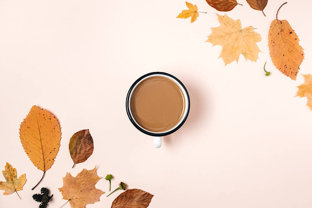 Autumn flat lay with various dry leaves and coffee cup on pastel beige studio background with copy space for advertisement. Thanksgiving, fall, halloween concept. Creative composition - Φωτογραφία, εικόνα