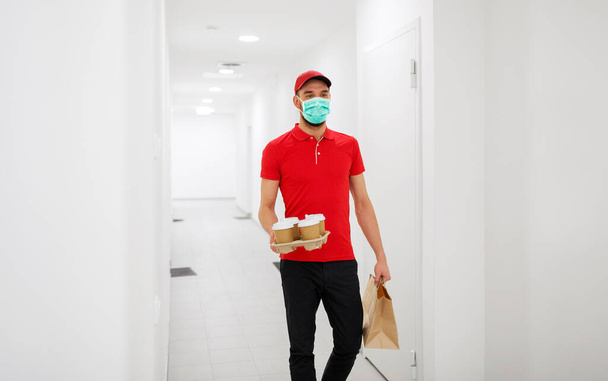 delivery man in mask with coffee and food - Photo, Image