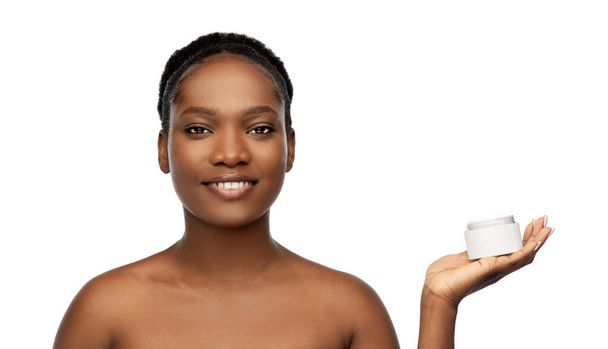 smiling african american woman with moisturizer - Фото, изображение