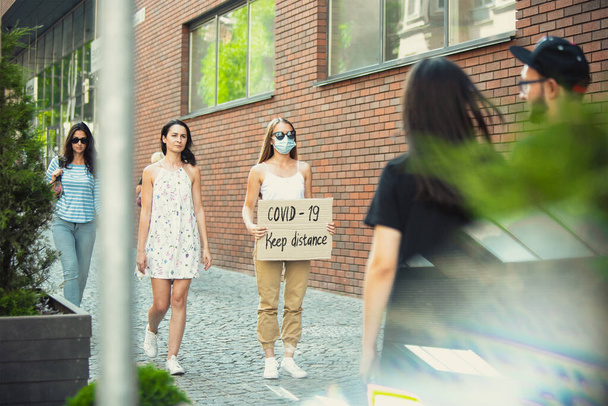 Dude with sign - woman stands protesting things that annoy him - 写真・画像