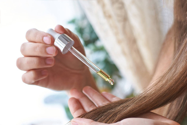 Hair care routine. Oil for head. Girl holding dropper - Photo, Image