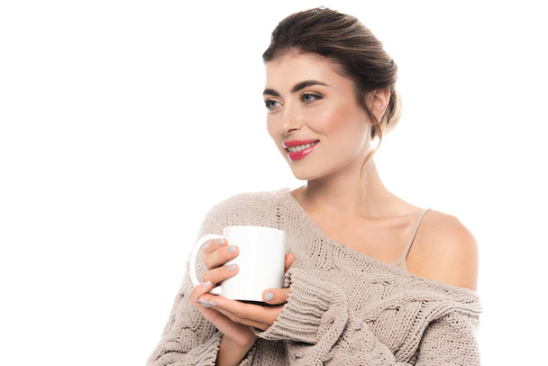 sensual woman in stylish knitted sweater holding cup of warm beverage isolated on white - Фото, изображение
