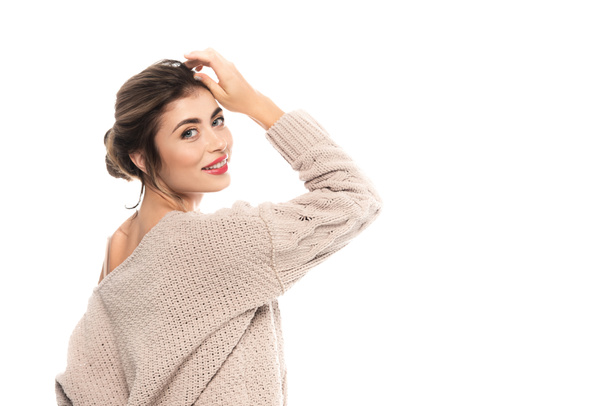 elegant woman in knitted sweater posing with hand near head isolated on white - Foto, Imagem