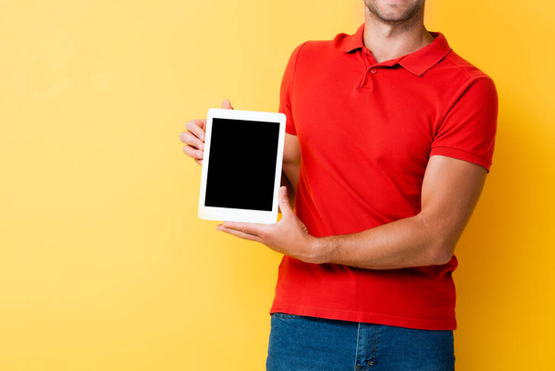 cropped view of man holding digital tablet with blank screen on yellow - Фото, изображение
