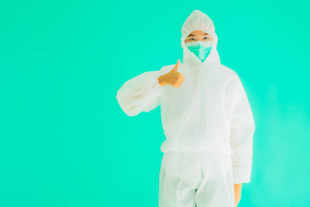 Portrait schöne junge asiatische Ärztin tragen ppe oder persönliche Schutzausrüstung zum Schutz vor Coronavirus oder covid19 auf blauem Hintergrund isoliert - Foto, Bild