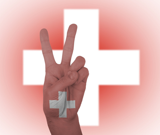 rukou znamení míru s vlajka Švýcarska - Fotografie, Obrázek