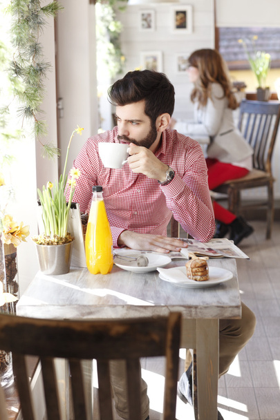 Modern young man sitting in coffee shop - Photo, image