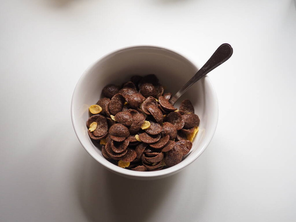 white recipe of chocolate cereals on a white table - Foto, imagen