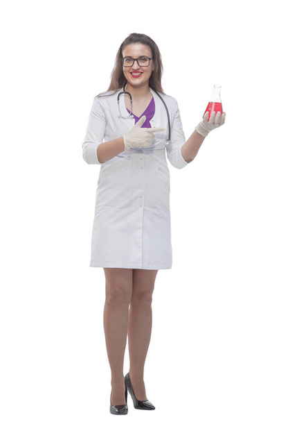 in full growth. female medic pointing to a bottle of liquid - Fotó, kép