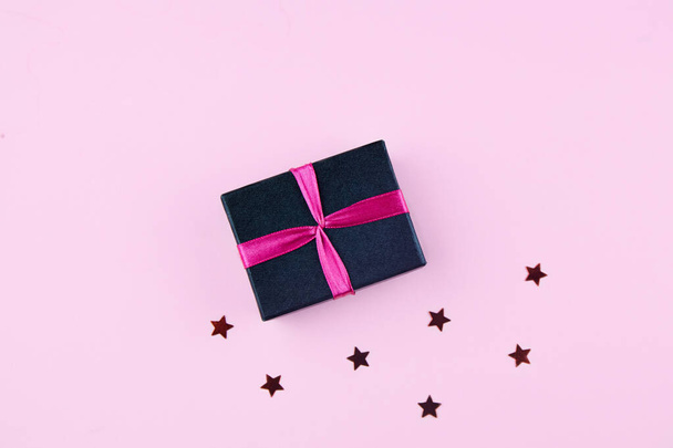 Gift on a pink background. Flat lay, top view, copy space. Christmas or birthday composition. - Fotoğraf, Görsel