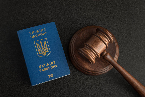 Ukrainian passport and judge gavel on gray black background. Legal immigration. Obtain citizenship - Photo, Image