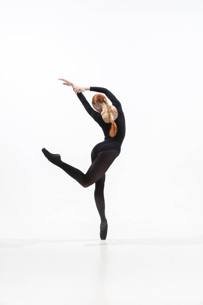 Young and graceful ballet dancer in minimal black style isolated on white studio background - Foto, Imagen
