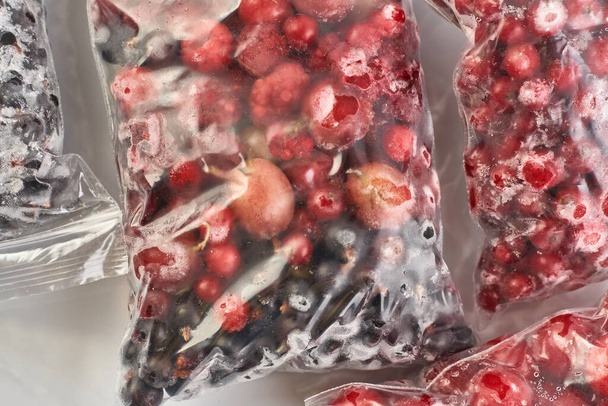Fagyasztó bogyók télre. Fagyasztott bogyók műanyag zacskókban. A fagyasztóban.. - Fotó, kép