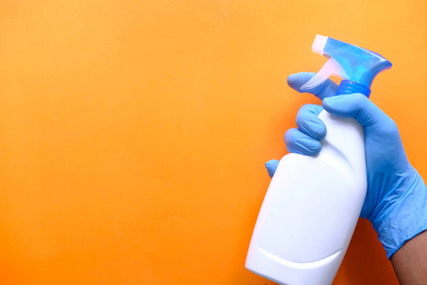 Person hand in disposable gloves holding disinfectant spray - Fotó, kép