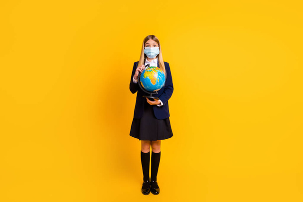 Full length body size view of her she nice attractive smart clever healthy long-haired girl holding in hand globe wearing gauze mask isolated bright vivid shine vibrant yellow color background - Foto, immagini