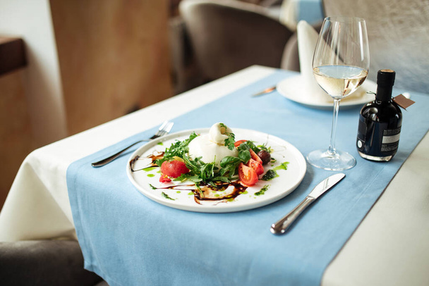 Spanish buratta salad with vegetables and greens - 写真・画像