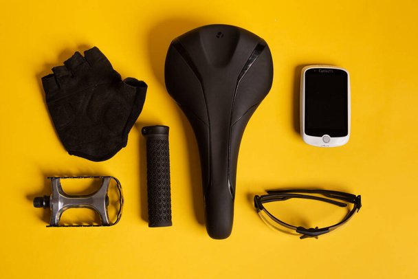 Bicycle, Cycling accessories on the yellow background. view from above - Photo, Image