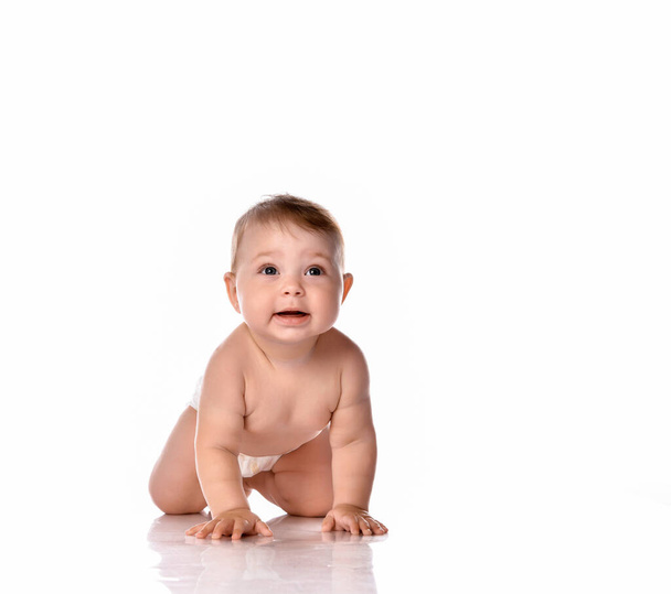 Happy smiling baby on floor over white background - Photo, image