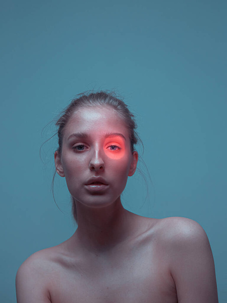 Female with perfect healthy skin and pink neon light spot on eye. Ad poster for skincare cosmetics - Zdjęcie, obraz
