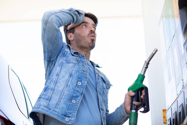 man in shock with gas price - Fotoğraf, Görsel