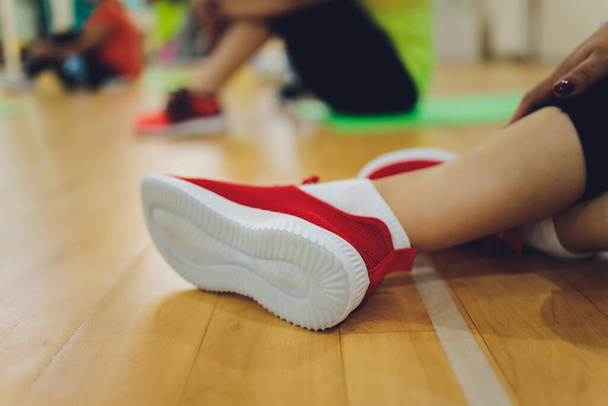 Fitness athletes foot close-up. Healthy lifestyle and sport concepts. Woman in fashionable sportswear is doing exercise. - Fotó, kép