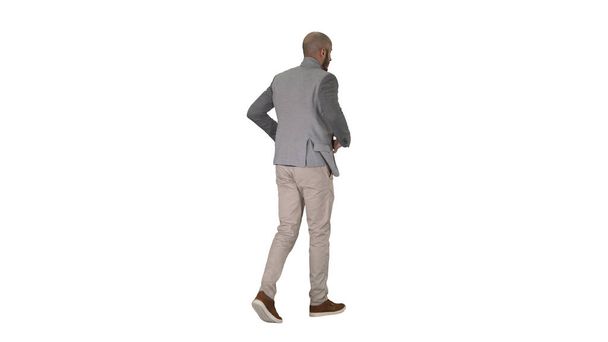 Casual man putting blazer on It is getting cold on white background. - Foto, Imagen