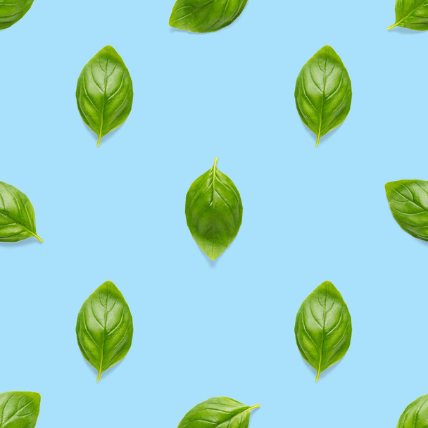 Italian Basil leaf herb seamless pattern on blue background, Creative seamless pattern made from fresh green basil flat lay layout. Food ingredient seamless pattern. - Photo, Image