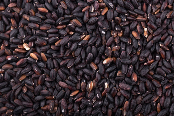 Close up background view of organic black purple rice - Photo, Image