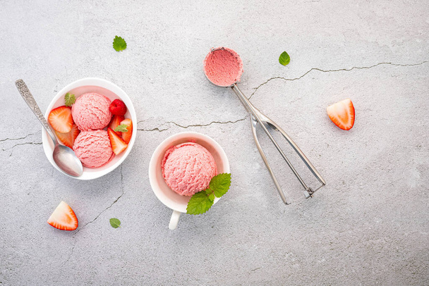 Strawberry  ice cream flavour in white  bowl setup on concrete background . Summer and Sweet menu concept. - Photo, Image