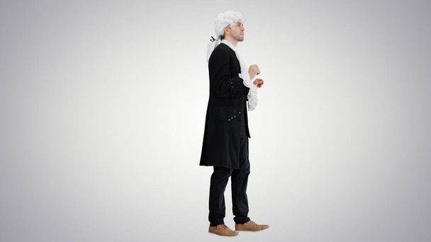 Man in old-fashioned laced frock coat and white wig thinking on - Фото, зображення
