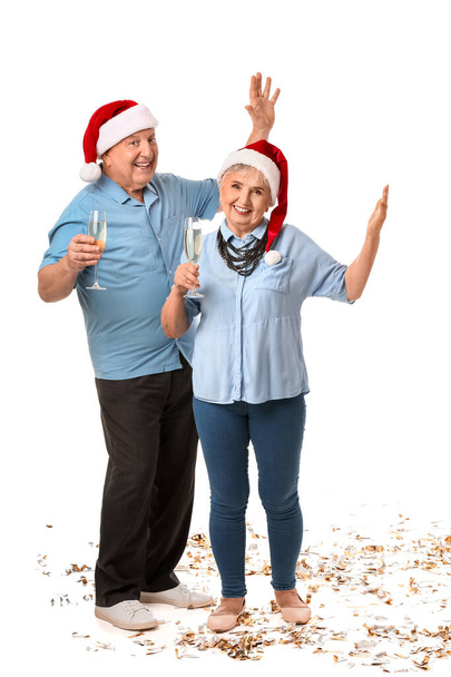 Elderly couple celebrating Christmas on white background - Photo, Image