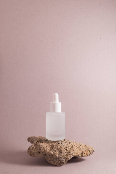 Natural serum for skin care in a dropper bottle on a light background. Modern skin care concept. - 写真・画像