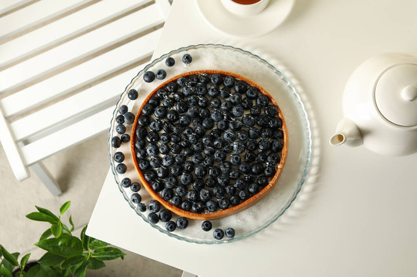 Concept of tasty breakfast with blueberry pie on white table - Fotó, kép