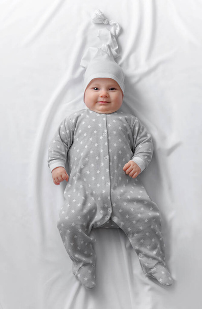 Cute smiling baby in bed after sleep - Photo, Image
