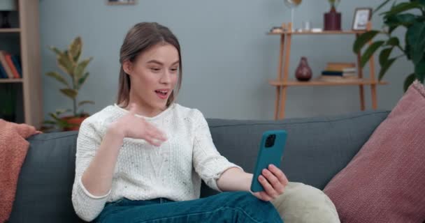 Attractive deaf woman having video call and showing with sign language Hello, Happy to see you. Female joyful person smiling and using smartphone for communication. Concept of hear loss. - Imágenes, Vídeo