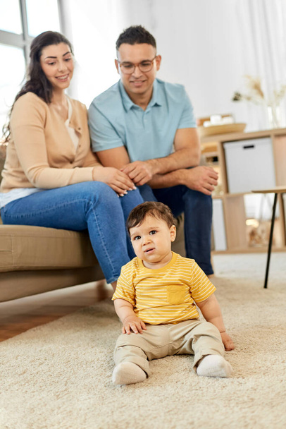 happy family with child sitting on sofa at home - Photo, Image