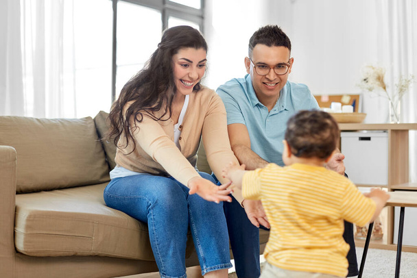 happy family with child sitting on sofa at home - Φωτογραφία, εικόνα